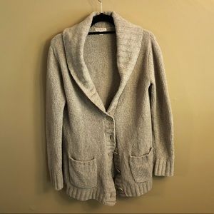 Metro a light brown fuzzy sweater.